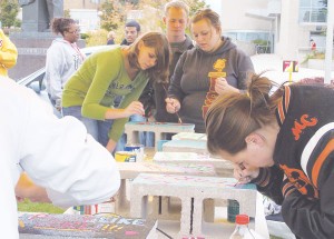 <span class='credit'>Photo By: Kristyn Sonnenberg | Photo Editor</span><span class='description'>Students paint bricks with demeaning words to be built into a Wall of Oppression and displayed before being torn down by the community. Bricks are still available  for painting between 11a.m. and 3p.m. today in the Quad.</span>