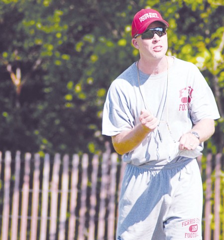 Offensive Change: The new offensive coordinator, Chris Boden, gives some advice during a football practice. Boden is ready to turn the offense around with a new system. Photo By: Kendall Baumann | Production Assistant