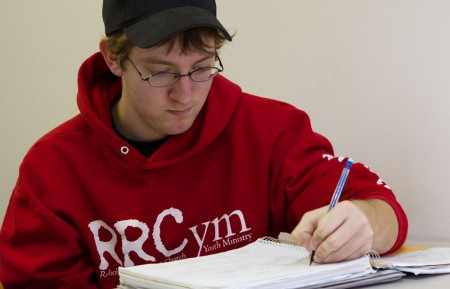 Studious Student: Tim Burke works on taking notes during his honors public speaking class. Photo By: Brock Copus | Photographer