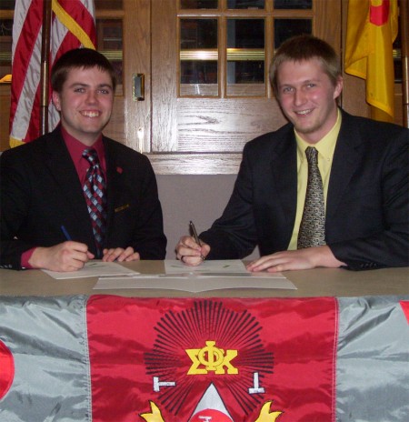 Frat Scholarship: Matt Valleau and William Mitch sign documents for the new Phi Sigma Kappa Emerging Leaders Scholarship available to incoming freshmen. The two fraternity brothers began planning the scholarship last summer. Photo Courtesy of Jacob Martin