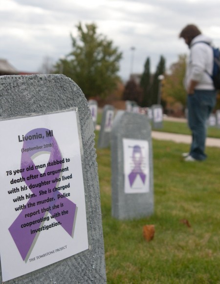 Domestic Violence Awareness: Michael Burlingame reads a part of the Tombstone Project, which is bringing awareness about domestic violence cases that have occurred the past few years in Michigan. Photo By: Kate Dupon | Photo Editor 