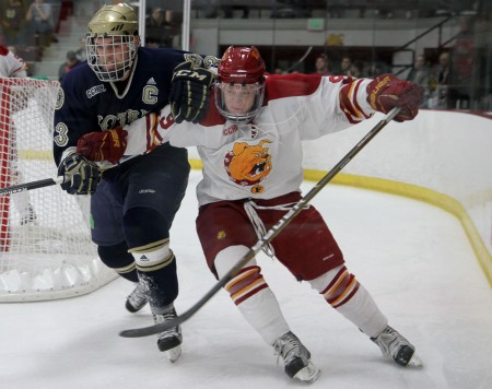 Losing to the Irish: Travis Ouellette pushes past a Notre Dame defender. The Bulldogs lost both games of the series to the Fighting Irish bringing the record to 16-14-4. Photo By: Brock Copus | Photographer