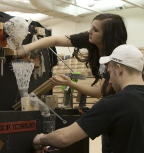 Complex Machines: Students from the Ferris State Rube Goldberg team work on making their machine just right for the Feb. 12 competition. Ferris currently holds two Guinness World Records for number of steps on a Goldberg machine. Photo By: Kate Dupon | Photo Editor