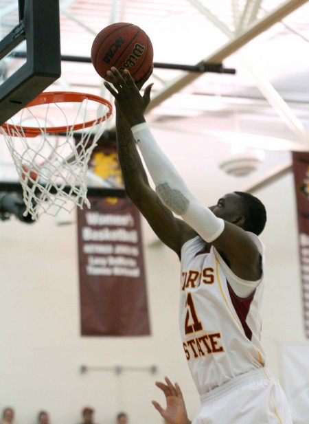 Reaching High: Senior Lou Williams reaches for a basket during the game against Grand Valley on Feb. 26. Williams holds the school record for blocked shots in a career. Photo By: Brock Copus | Photographer