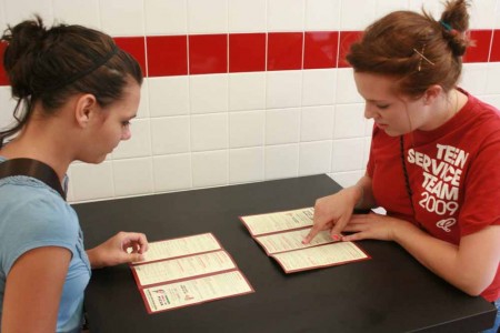 Pizza Anyone?: Hope Mulligan and Brianne Cleary, Ferris students, try to decide what to order off the Jet’s Pizza menu. Jet’s Pizza opened on Monday, Sept. 12.Photo By: Kate Dupon | Photo Editor