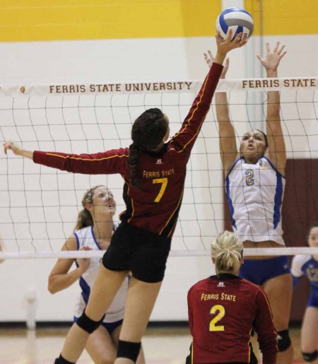 Battling LSSU: Anne Sutton, senior middle hitter, reaches to return a ball during the match against LSSU. Photo By: Brock Copus | Multimedia Editor