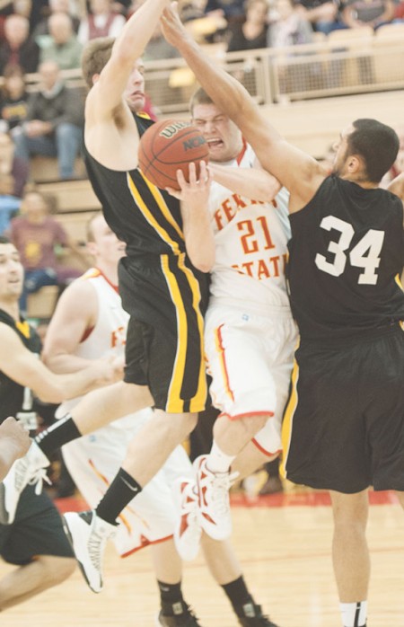 Unleashing the Beast: Sophomore Drew Lehman fights through a foul against Michigan Tech in a 74-66 home victory over Tech. Photo Courtesy of Photographic Services
