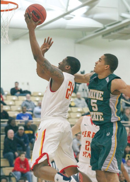 Laying it In: Ferris State senior forward Daniel Sutherlin attempts a shot against Wayne State. The Bulldogs thrilled the crowd with a double overtime victory over the undefeated in conference play Warriors. Photo By: Brock Copus | Multimedia Editor