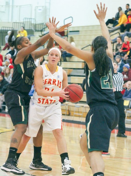 Double Teamed: Lady Bulldog Ashley Rando holds the ball away from Wayne State defenders. Ferris State would fall 81-68. Photo By: Brock Copus | Multimedia Editor