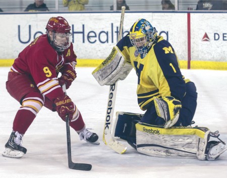 Shootout Stuffed: Ferris senior center Travis Ouellette attempts to even up the shootout score by sliding the puck under Michigan goaltender Steve Racine. The Bulldogs were shutout in the shootout with a lone Michigan goal, giving the Wolverines the shootout victory. Photo By: Brock Copus | Multimedia Editor