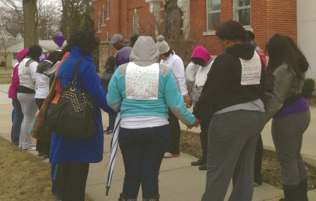 Hands in Prayer: Participants of the Walk Against Domestic Violence pause for a moment of reflection during their walk through downtown. The walk was collaborated by My Sister’s Keeper and Women’s Information Services, Inc. (WISE). Photo By: Sean Chipman | Ferris State Torch