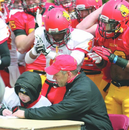 Bulldog Pup: Head coach Tony Annese sits down with cancer survivor Keegan Bulk as he signs his letter of intent at the annual Crimson and Gold Spring Football Game. Photo By: Brock Copus | Multimedia Editor