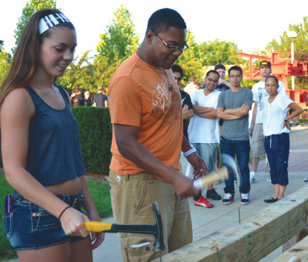 Hammer Time: Ferris forensic bio and pre med major Celia Robinson and Ferris mechanical engineering Lonnie Likely race to see if they can hammer a nail in to a board with a straight arm only using seven hits. Photo By: Olivia Odette | Photographer