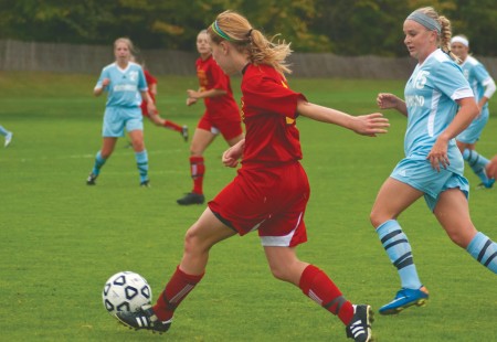 Looking for Victory: Ferris senior defender Amanda Foster looks for an open teammate during last season’s game against Northwood. The Bulldogs defeated Northwood in overtime and will look to secure a similar victory this season.  Torch File Photo