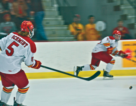 Defenseman Connor Schmidt moves the puck up the rink in the game against St. Lawrence, the Bulldogs split the weekend series with St. Lawrence. Last weekend the Bulldogs went on to sweep Alabama-Huntsville and are looking for victories at home against Bemidji State on Nov. 8 and 9. Photo Courtesy of Harrison Watt