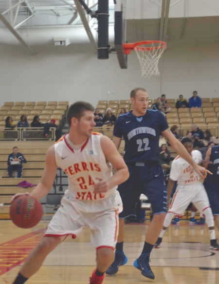 Junior guard Matt Poches goes up against a Northwood offender during the home game on Jan 23. The Bulldogs lost 66-65 but hope to end their 8-game losing streak when they go up against Grand Valley on Feb. 3.  Photo By: Olivia Odette | Photographer