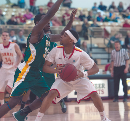 Junior guard Deitrich Lever fights his way through a Wayne State defender for a basket this past Thursday. Despite their tough efforts and skills on the court, the Men’s basketball team fell two spots short of the top eight in the conference ranking and won’t be competing in the 2014 GLIAC Tournament. Photo By: Tori Thomas | Photographer