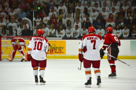 (Photo By: Harrison Watt, Sports Editor) Ferris defensemen Ryan Lowney (Freshmen) and Jason Binkley (Junior) skate towards the Dawg Pound on October 18, 2013.