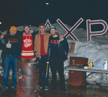 Members of Alpha Chi Rho (AXP) brace the bitter cold night as they camp out in the North Quad as part of their annual fundraiser for Habitat for Humanity. Photo By: Olivia Odette | Photographer