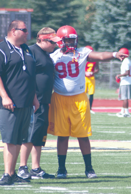 Junior defensive lineman Corey Stone works with Ferris football assistant coaches during the 2013 preseason workouts.  Courtesy Photo By: Bill Bitzinger | FSU Photo Services