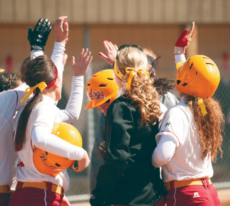 Ferris softball celebrates in the 2013 season during which the weather lifted much earlier in the year. This season, the lady Bulldogs are still waiting to play their first outdoor game.  Torch File Photo