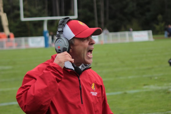 Football Head Coach Tony Annese shouts directions at his team during a victory. The Bulldogs remain undefeated headed into their biggest test of the year.