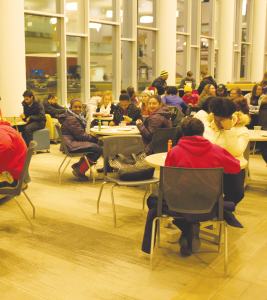 A group of students enjoy hanging out in the University Center. There were fun activities like a DJ and henna tattoos.