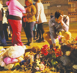 A Memorial of flowers, candles and gifts in the street where Michael Brown’s body lay for hours uncovered in Ferguson, Missouri.