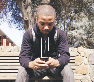 Cameron Henry texts using his iPhone at Stanford University in Stanford, California.