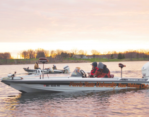 Members of the Ferris State Fishing Club brave the cold in an early morning tournament out on the lake.