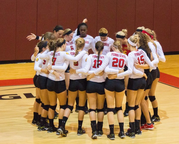 The Dawgs reconvene on the court during a stoppage in play to ready themselves for the next set.