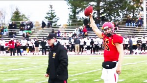 Head Coach Tony Annese hands off a game ball to quarterback Jason Vander Laan after his 53-yard touchdown run pushed him past the previous record for rushing yards at the quarterback position. Vander Laan salutes the home crowd as the new record holder, currently standing at 5,218 rushing yards with at least four games left to play.