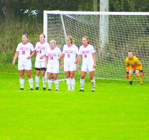 The Ferris State defense lines up to block a free kick. Goalie Maddie Haustein prepares to make the save.