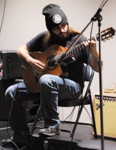 Freshman pre-pharm major John McClelland strums a solo piece on guitar. 