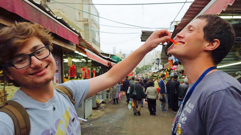 Torch staff member Travis Sacher feeds Israel Defense Forces soldier Yuval (Ovlov) Safran a gummy worm in Tel Aviv, Israel. Sacher spent 10 days with Safran in Israel over winter break.