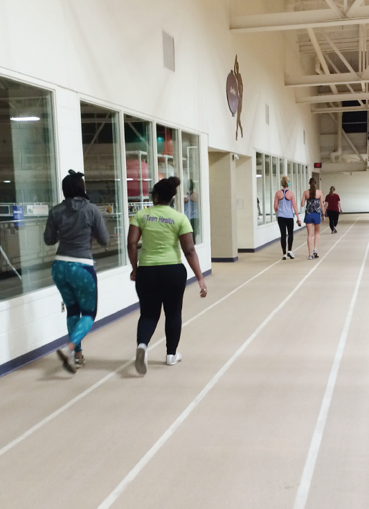 Big Rapids residents Toya Brown (left) and Jasmine Brown (right) circle the track in the Rec Center.