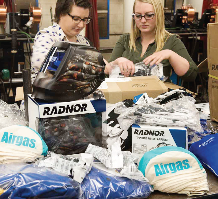 Ferris welding engineering technology students Kate Wernecke (left) and Bobbi Jo Matheny (right) sort through welding supplies donated to the school by Airgas, Inc.