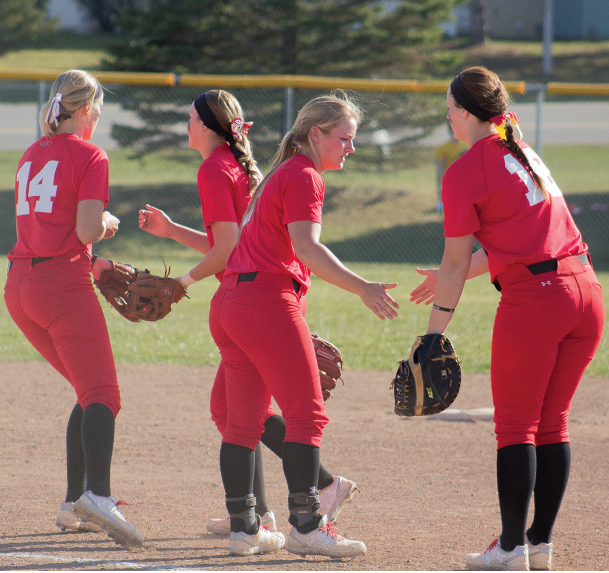 The Bulldogs high five in their first home game of a long season. The team will play a majority of their final games in Big Rapids.