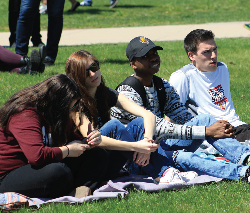 Students kick back and enjoy the sunshine and music at Music Takes Action in the Quad on Saturday, April 23.