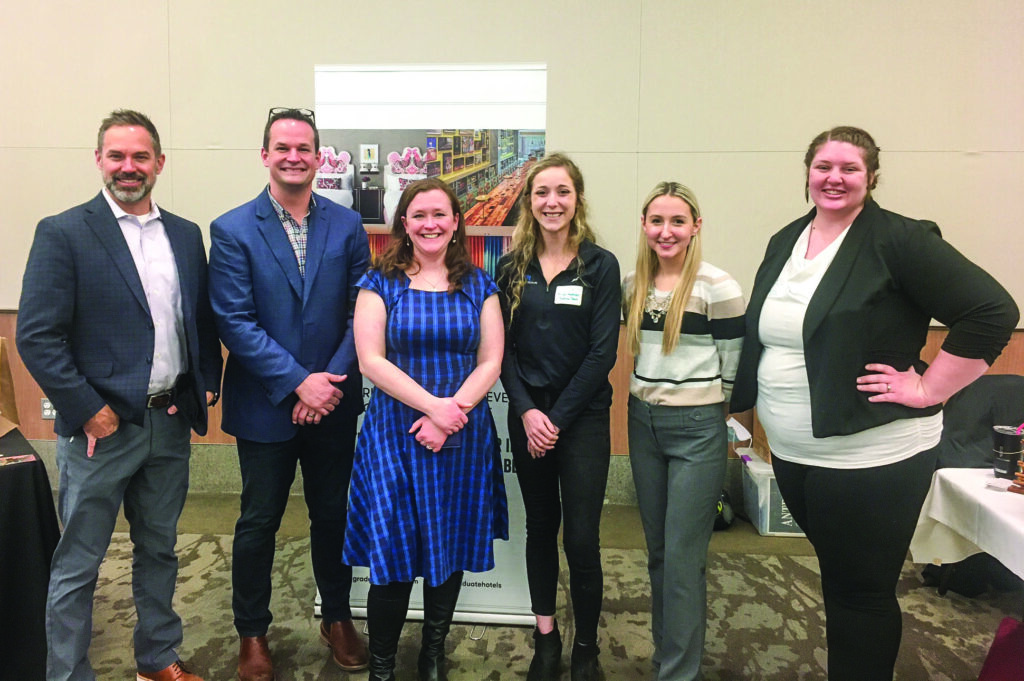 Hospitality alumni gather for a group photo while recruiting for their companies