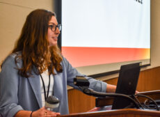 Caroline Jasin, president of the MCA stands a podium adressing the attendees of Mediafest